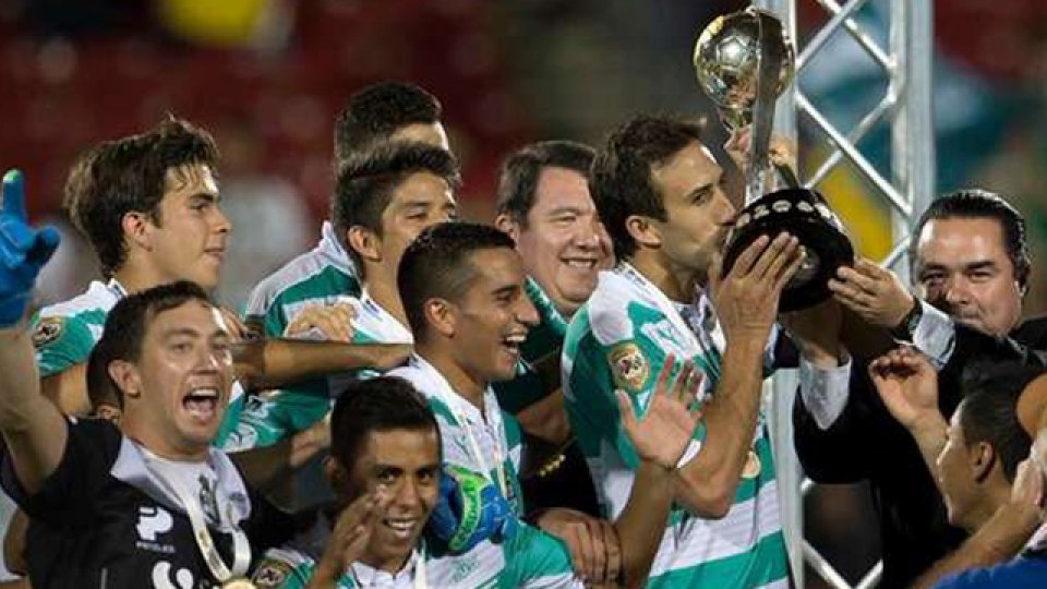 El capitán Izquierdoz levanta el trofeo junto a Marchesín y el Pulpito González.