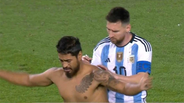 Un hincha entró al campo y le pidió a Messi que le firme la espalda.